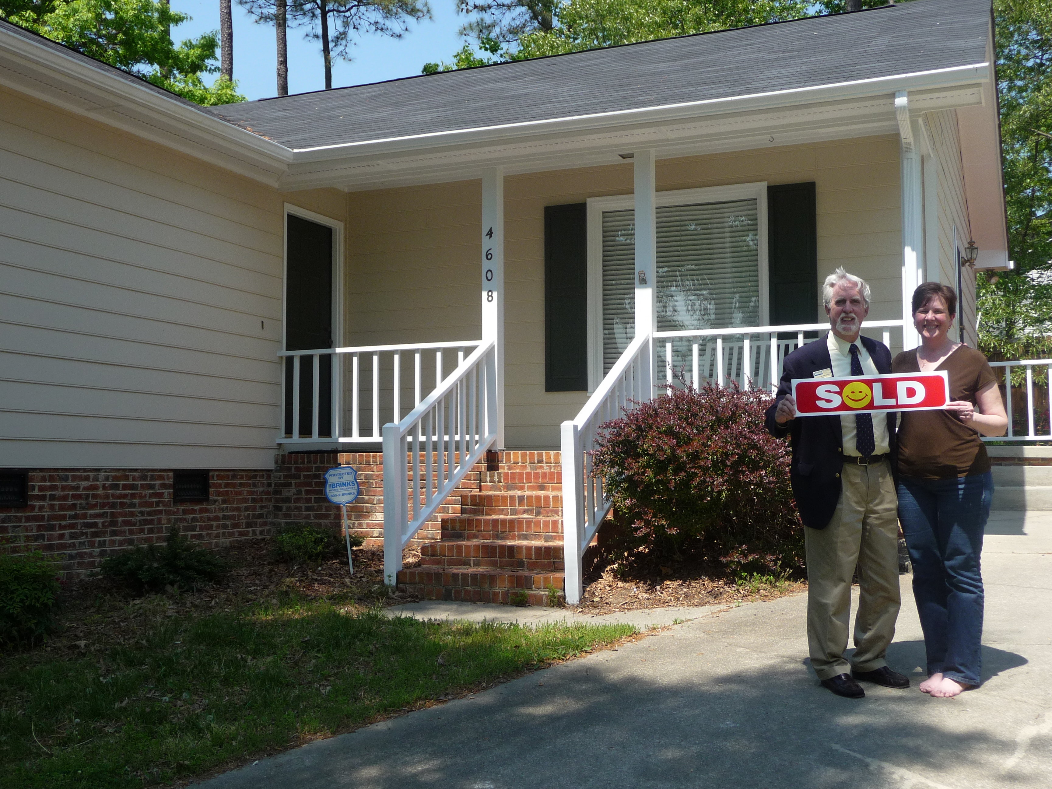 Betsy Hord and Tim in front of her old house