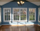 Beautiful sunroom with cathedral ceiling, view to private backyard and deck, and french doors to family room. no image