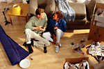 couple sitting in home with packed boxes