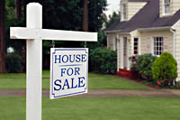 for sale sign on front lawn