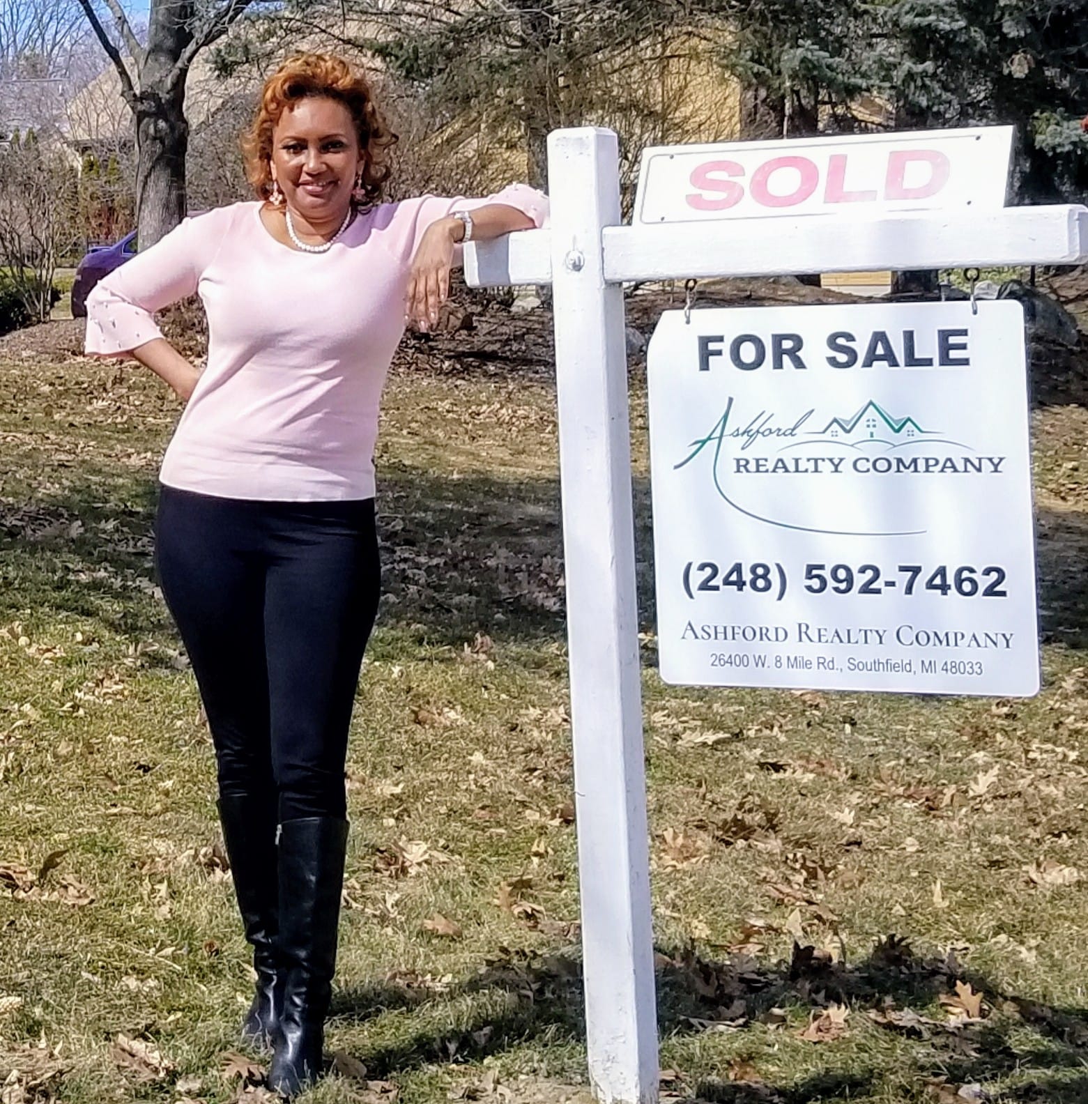 Leslie Ashford with Ashford Realty For Sale sign